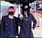 An image of Shinya and Mana-Sama outside under a gothic umbrella while making a youtube video for Shinya's channel